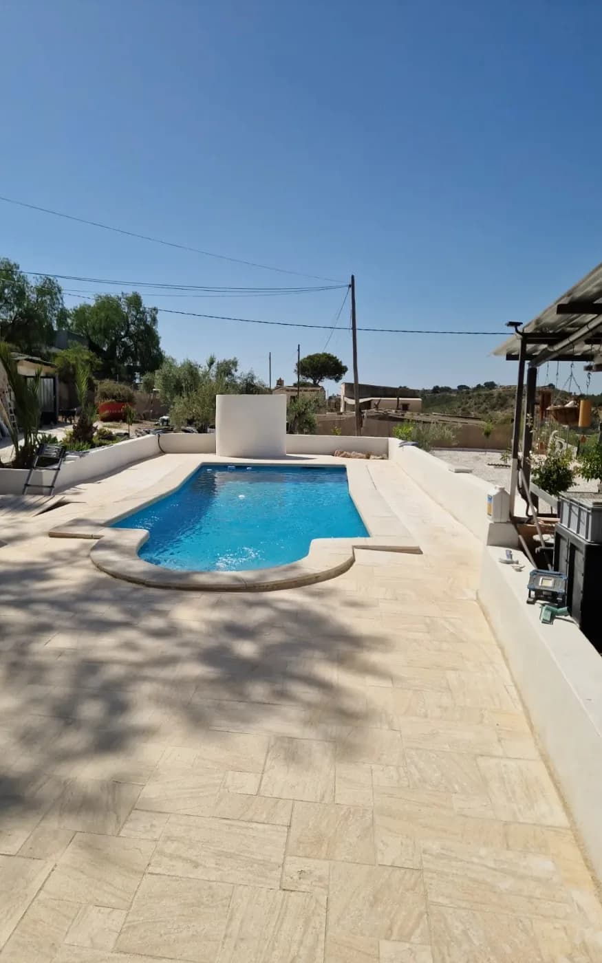 After: travertine poolside terrace. Source: Handwerker Costa Blanca gallery.