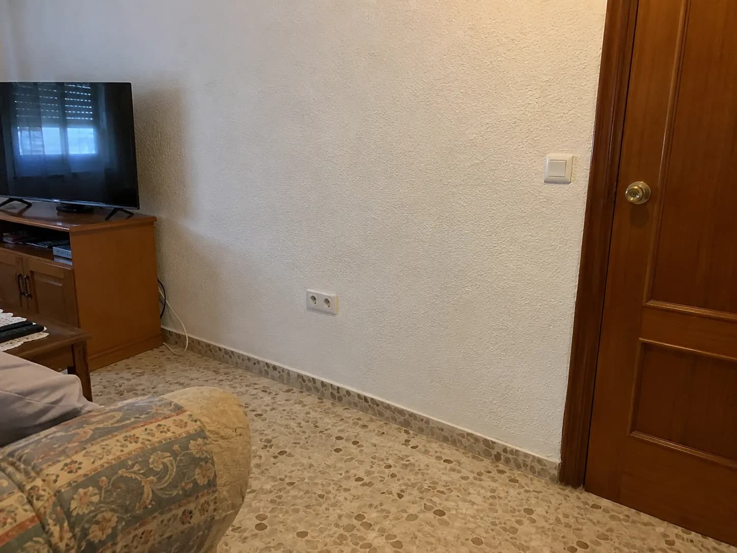 Living room after the rewire, with a new double socket and light switch