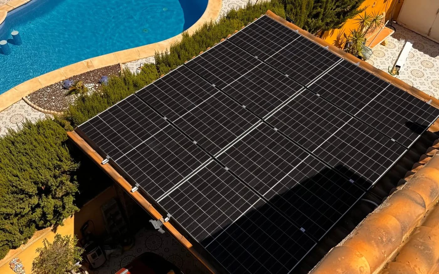 Completed solar panel array on the roof of the garden structure.