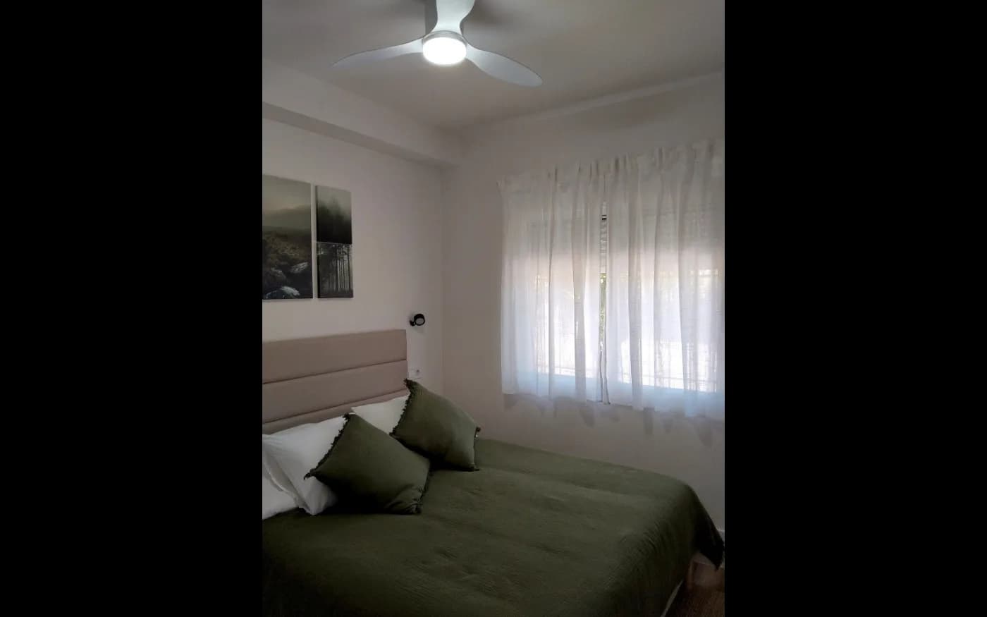 Bedroom after repainting, with fresh white walls and ceiling.