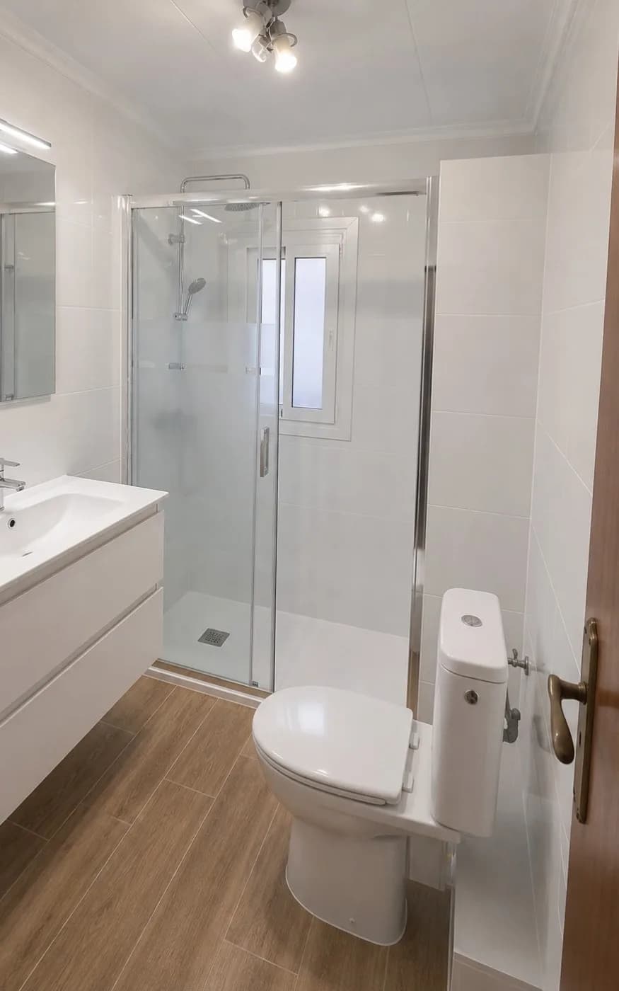 Giron bathroom after renovation — shower, vanity and updated finishes. Official project gallery.